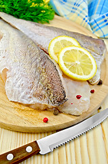 Image showing Fillets codfish on a board with a knife