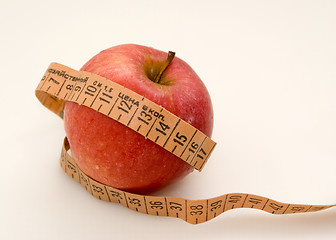 Image showing Red apple with measuring tape