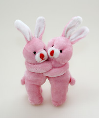Image showing Two pink rabbits cuddling
