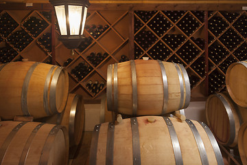 Image showing Wine Barrels and Bottles in Cellar