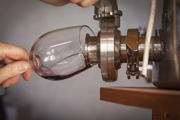 Image showing Vintner Pours Taste of Wine from Barrel into Glass