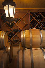 Image showing Wine Barrels and Bottles in Cellar