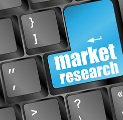 Image showing Blue key with market research text on laptop keyboard