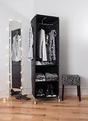 Image showing Mirror and mobile wardrobe with clothing