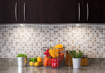 Image showing Vegetables, fruits and herbs in a kitchen with cozy lighting