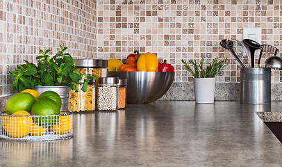 Image showing Kitchen countertop with food ingredients and herbs