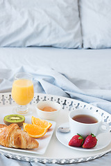 Image showing Tray with tasty breakfast on a bed