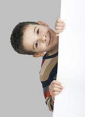 Image showing Little boy holding a whiteboard