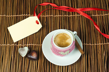 Image showing Cup of coffee with knitted heart symbol