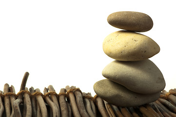 Image showing Stacked stones on wooden base