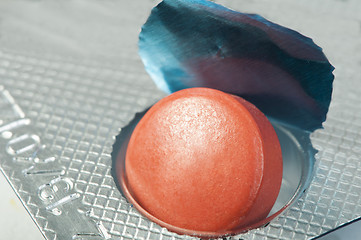 Image showing Red pill in a pack very close up