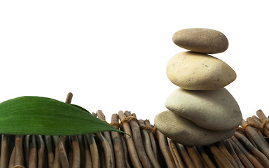 Image showing Stacked stones on wooden base