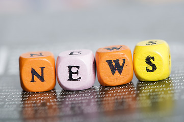 Image showing Word news.Wooden cubes on magazine