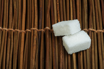 Image showing Sugar lumps on wooden base