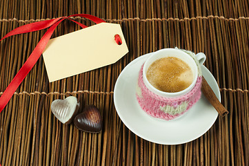 Image showing Cup of coffee with knitted heart symbol