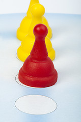 Image showing Red and yellow game pawns white isolated