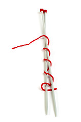 Image showing Knitting skewers and red yarn