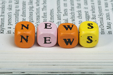 Image showing Word news.Wooden cubes on magazine