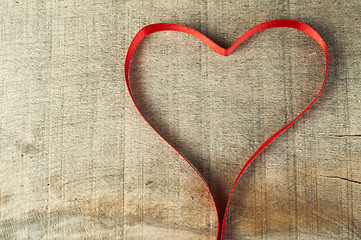 Image showing Red ribbon heart on wooden background