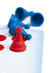 Image showing Red and blue game pawns white isolated