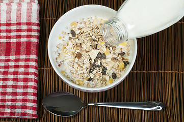 Image showing Muesli breakfast in package.Bottle milk and spoon