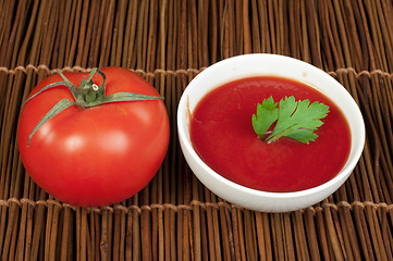 Image showing Tomato and Bowl of tomato sauce