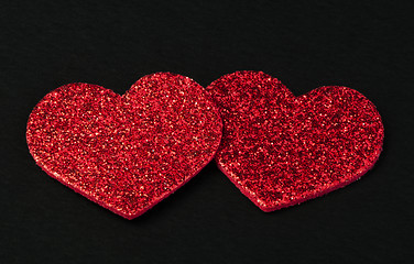 Image showing Red shiny hearts on black background