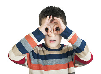 Image showing Child looking through his ??hands