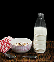 Image showing Muesli breakfast in a bow, spoon and milk