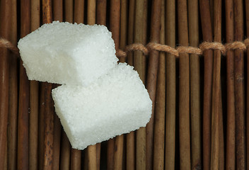 Image showing Sugar lumps on wooden base