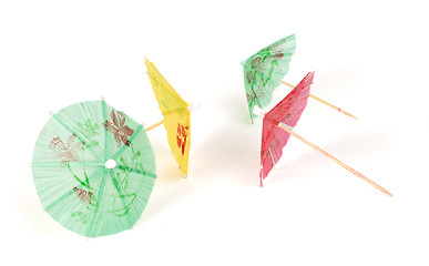 Image showing Colorful cocktail umbrellas white isolated