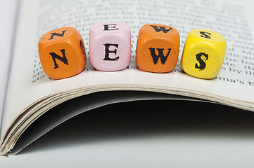 Image showing Word news.Wooden cubes on magazine