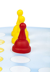 Image showing Red and yellow game pawns white isolated