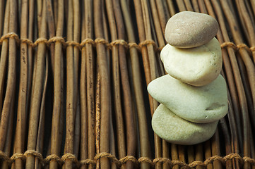 Image showing Stacked stones on wooden base