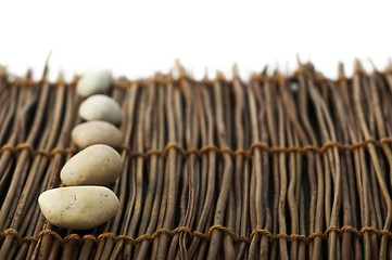 Image showing Stacked stones on wooden base