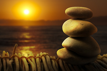 Image showing Stacked stones on wooden base for spa