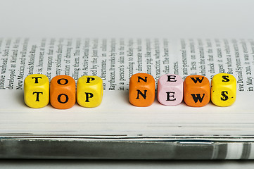 Image showing Word top news.Wooden cubes on magazine