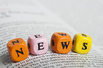 Image showing Word news.Wooden cubes on magazine