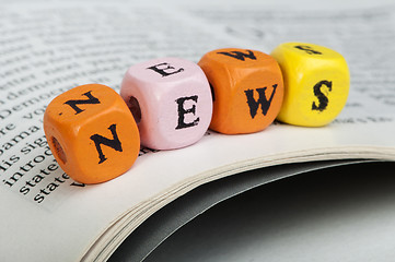 Image showing Word news.Wooden cubes on magazine