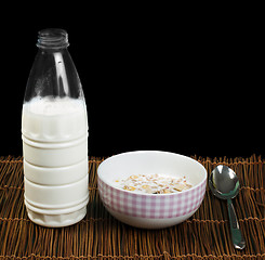 Image showing Muesli breakfast in a bow, spoon and milk