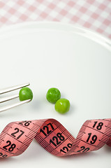 Image showing Plate with peas and centimeter measure