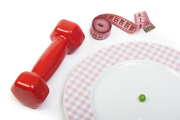 Image showing Plate with one peas. Dumbbell and centimeter measure. 