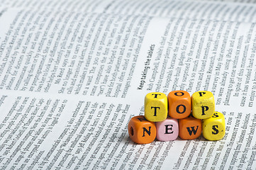 Image showing Word top news.Wooden cubes on magazine