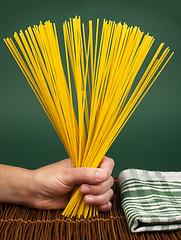 Image showing Female hand holding spaghetti