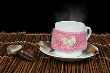 Image showing Cup of coffee with knitted heart symbol