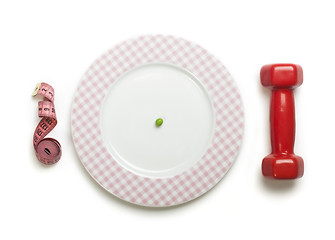 Image showing Plate with one peas. Dumbbell and centimeter measure. 