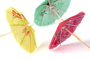 Image showing Colorful cocktail umbrellas white isolated