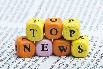 Image showing Word top news.Wooden cubes on magazine