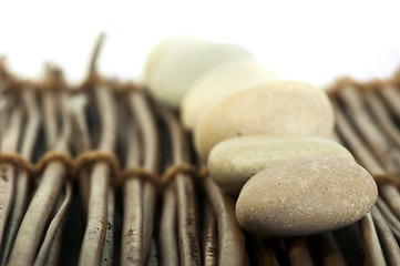 Image showing Stacked stones on wooden base