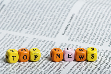Image showing Word top news.Wooden cubes on magazine